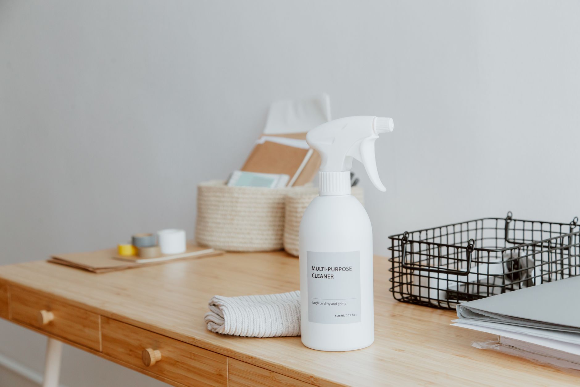 Cleaner wiping down office desks and touch surfaces, showing the higher-touch hygiene work that gained time after vacuuming was reallocated.