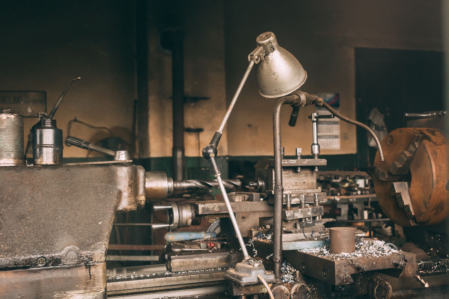 Machine shop interior where engineers integrate a collaborative tending cell beside existing equipment.
