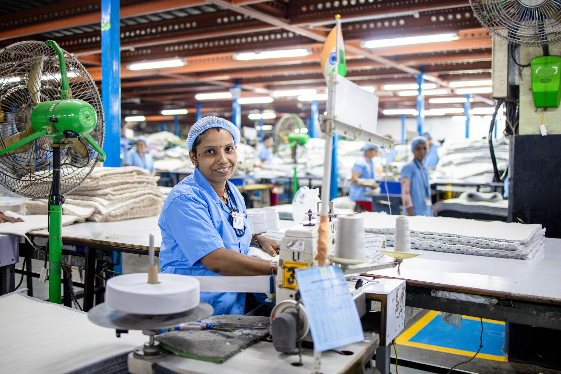 Production staff on an automotive line, representing labor redeployed after tending automation.