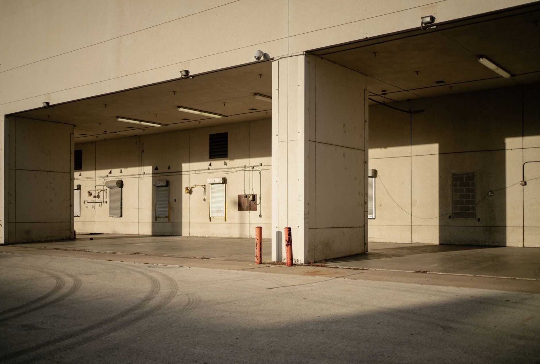 A tight industrial doorway where forklifts cannot enter, matching the choke point for guided tank movement.