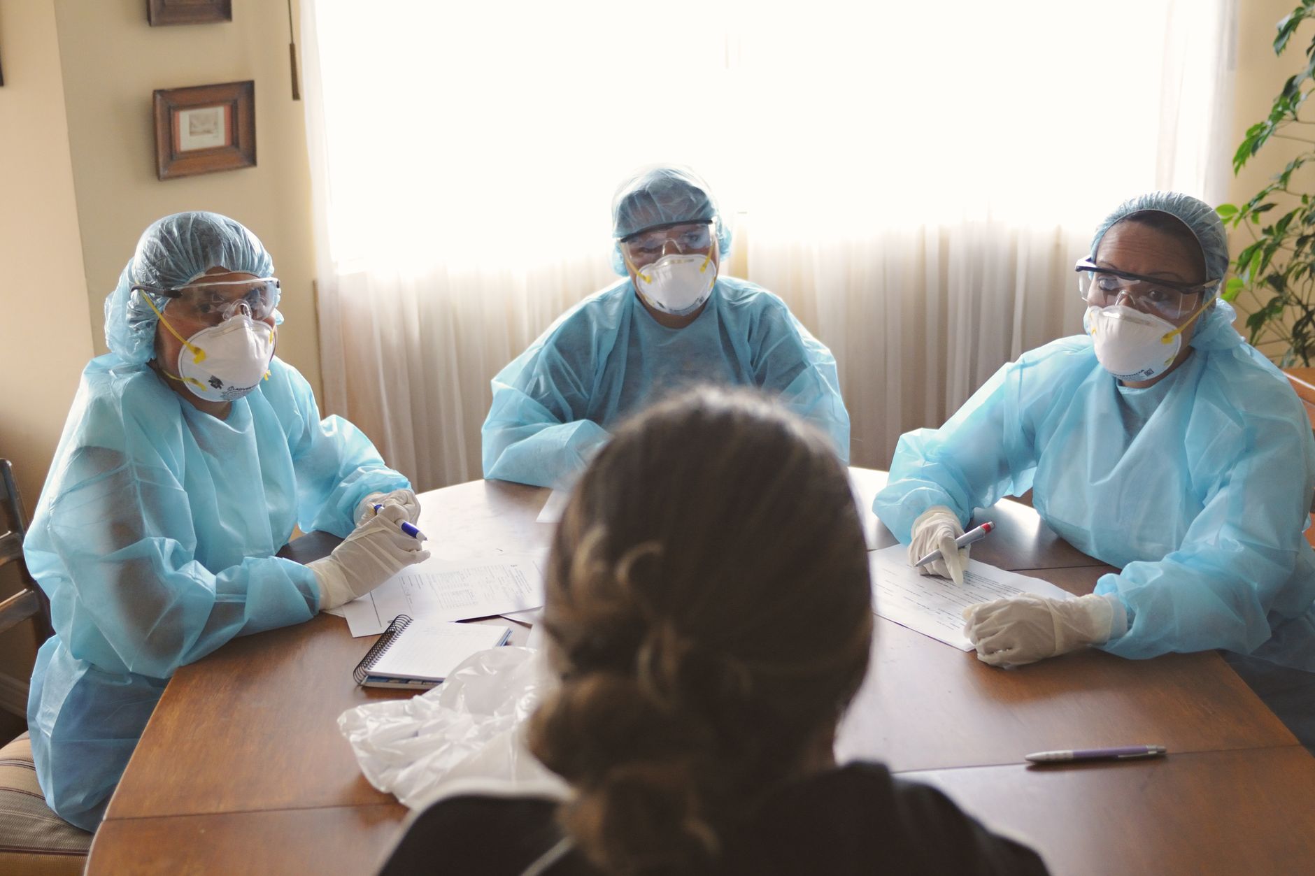 A senior living care team meets around a table to plan consistent resident support.