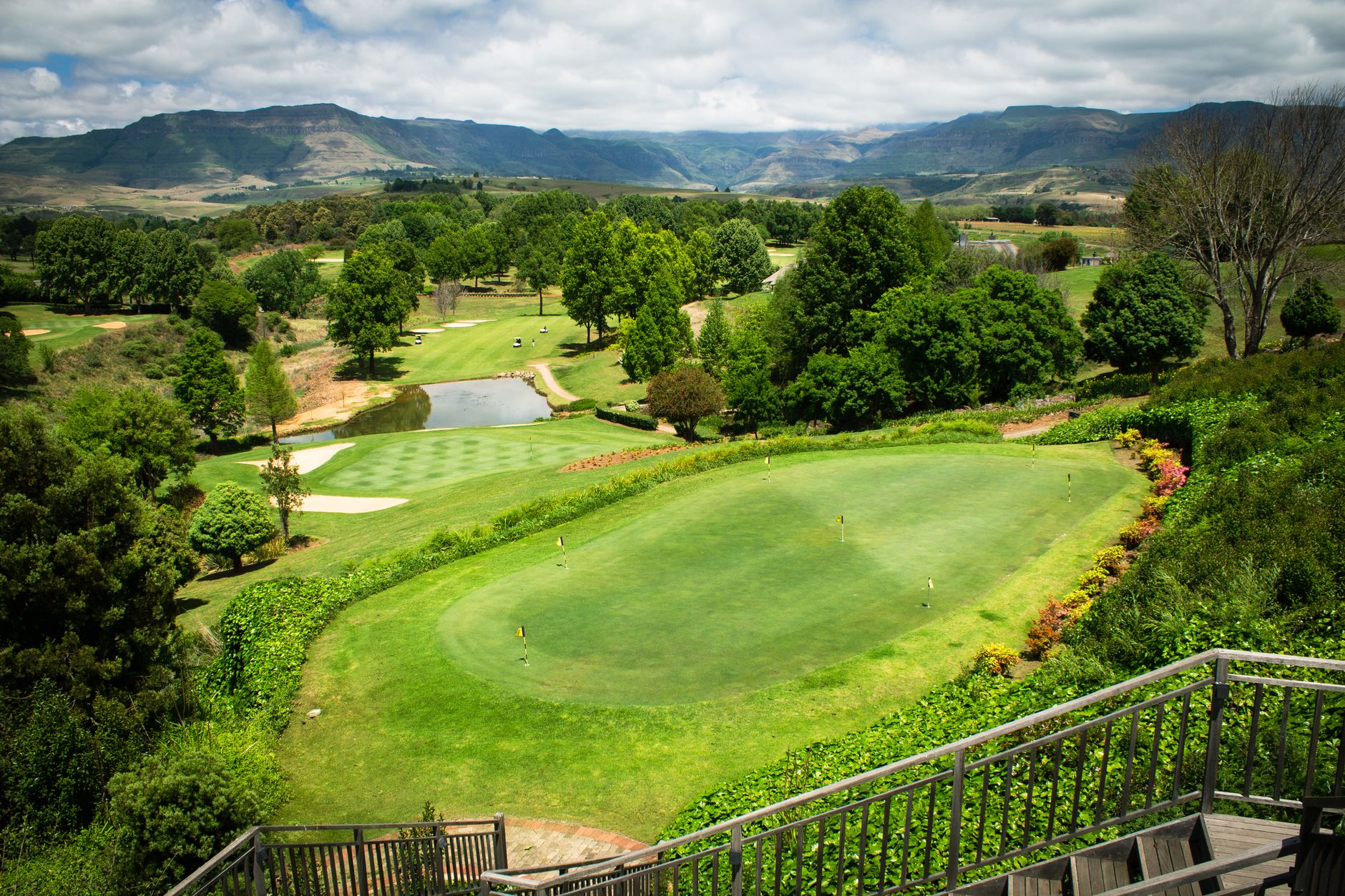 Aerial view of a picturesque golf course with lush greenery and scenic hills, perfect for sports and leisure