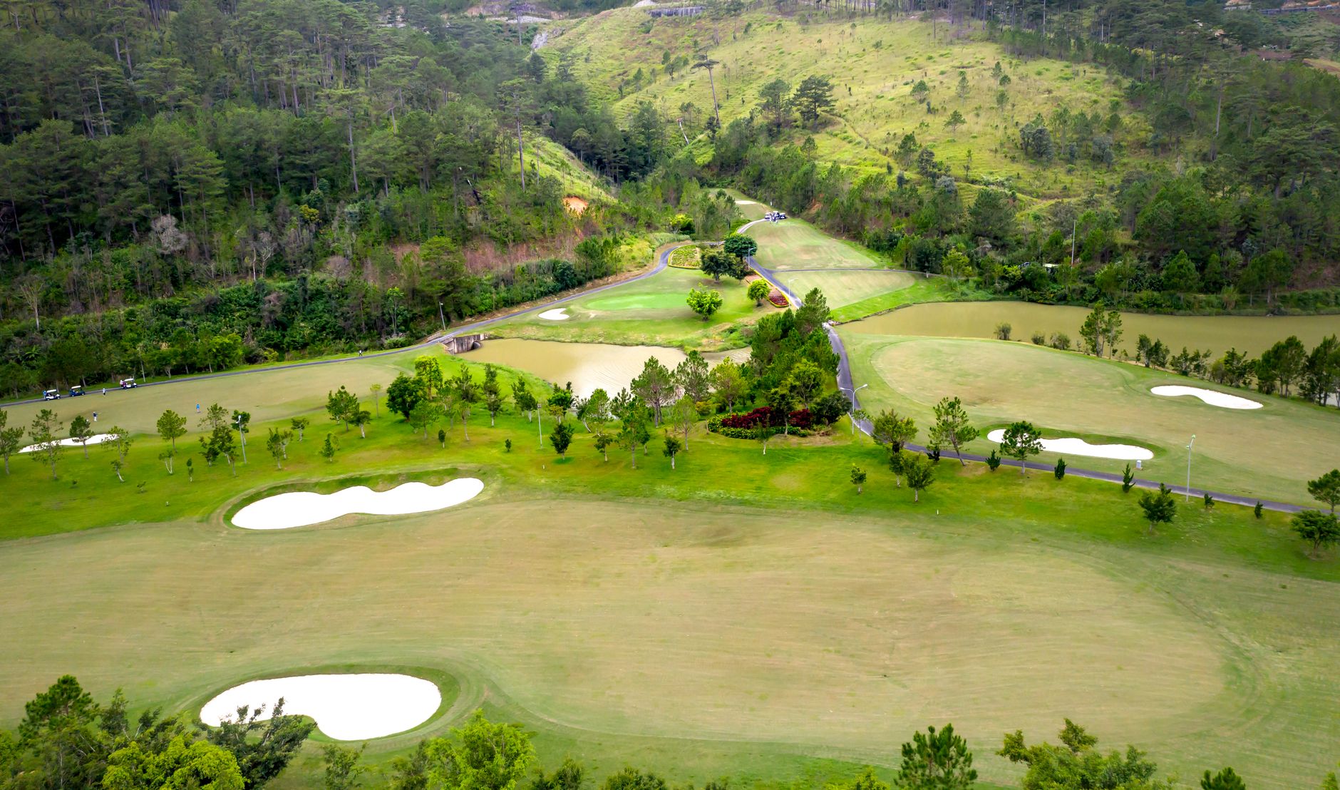 Aerial shot capturing the lush greenery and tranquil landscape of a scenic golf course