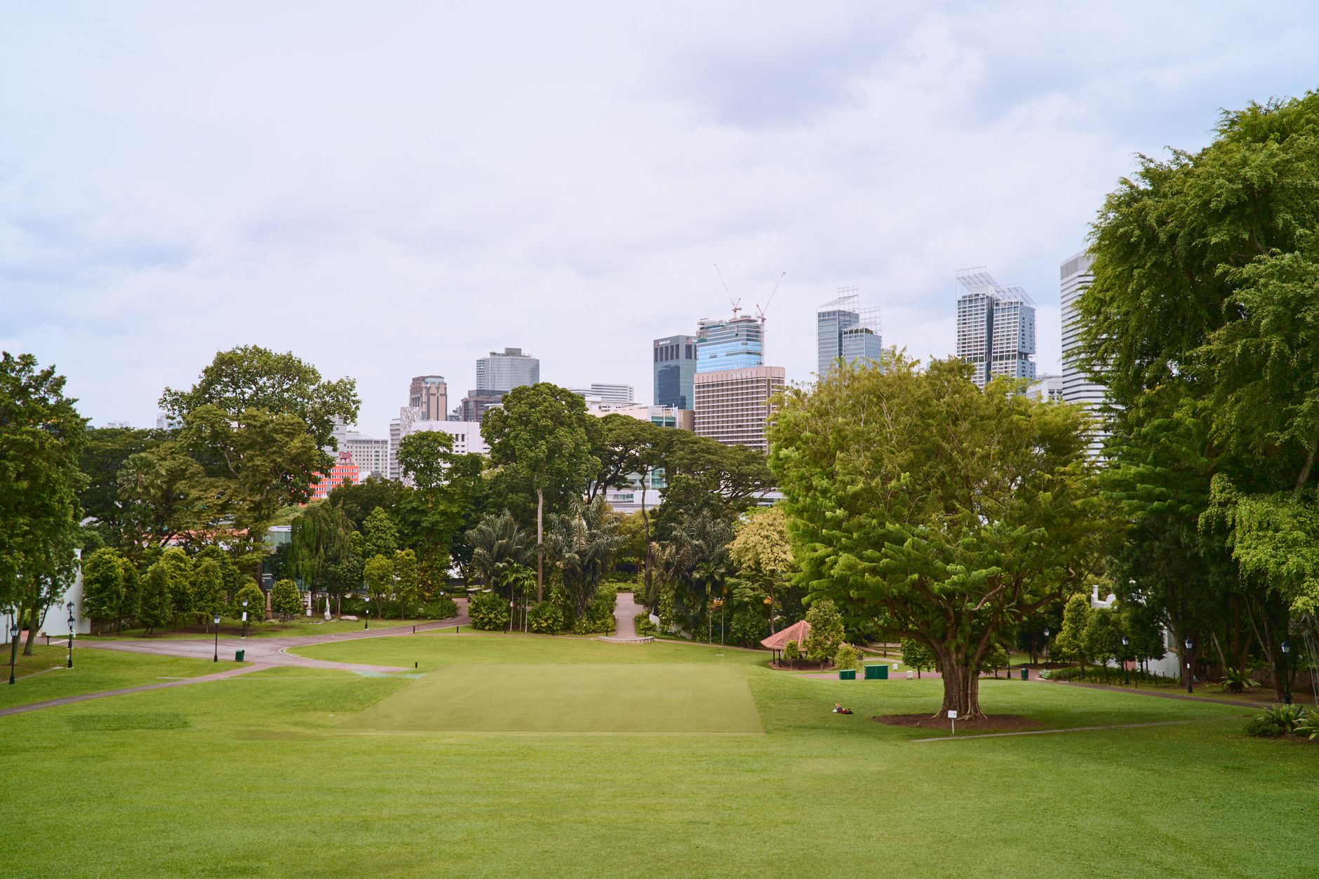 Green golf course with city skyline in the background, ideal for business and leisure themes