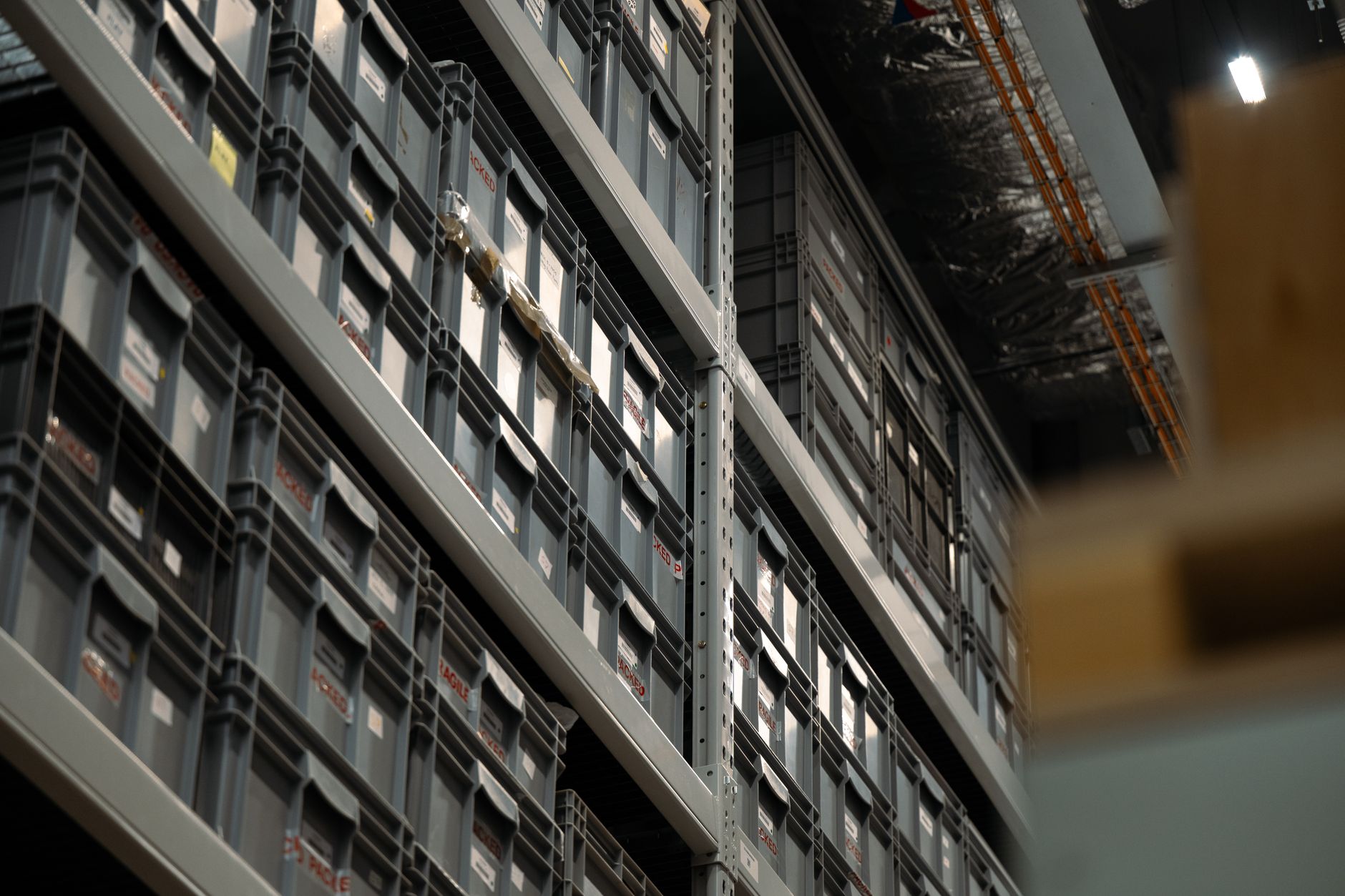 Shelves of boxed medicine stock in a storage room, the kind of controlled space a pharmaceutical warehouse keeps organized.