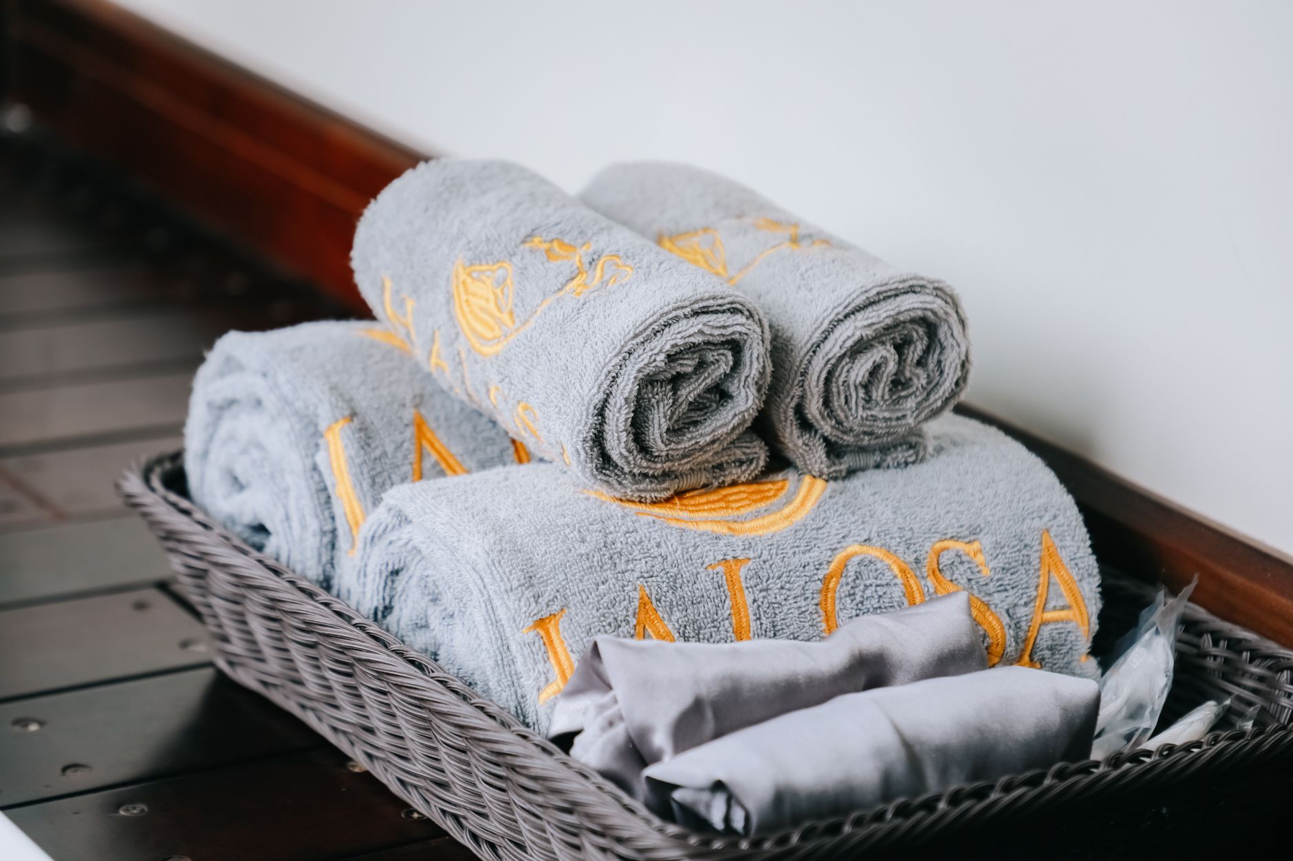 Neatly folded white hotel towels arranged in tidy piles on a clean work surface.