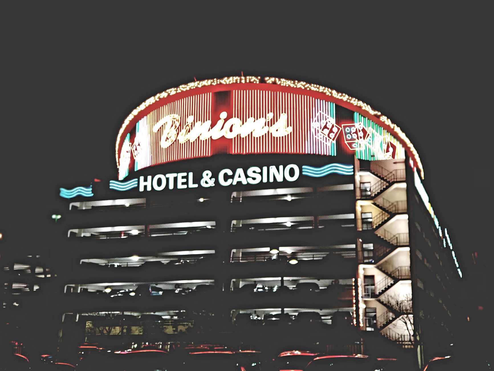 A large casino hotel lobby at night with guests walking across polished floors.