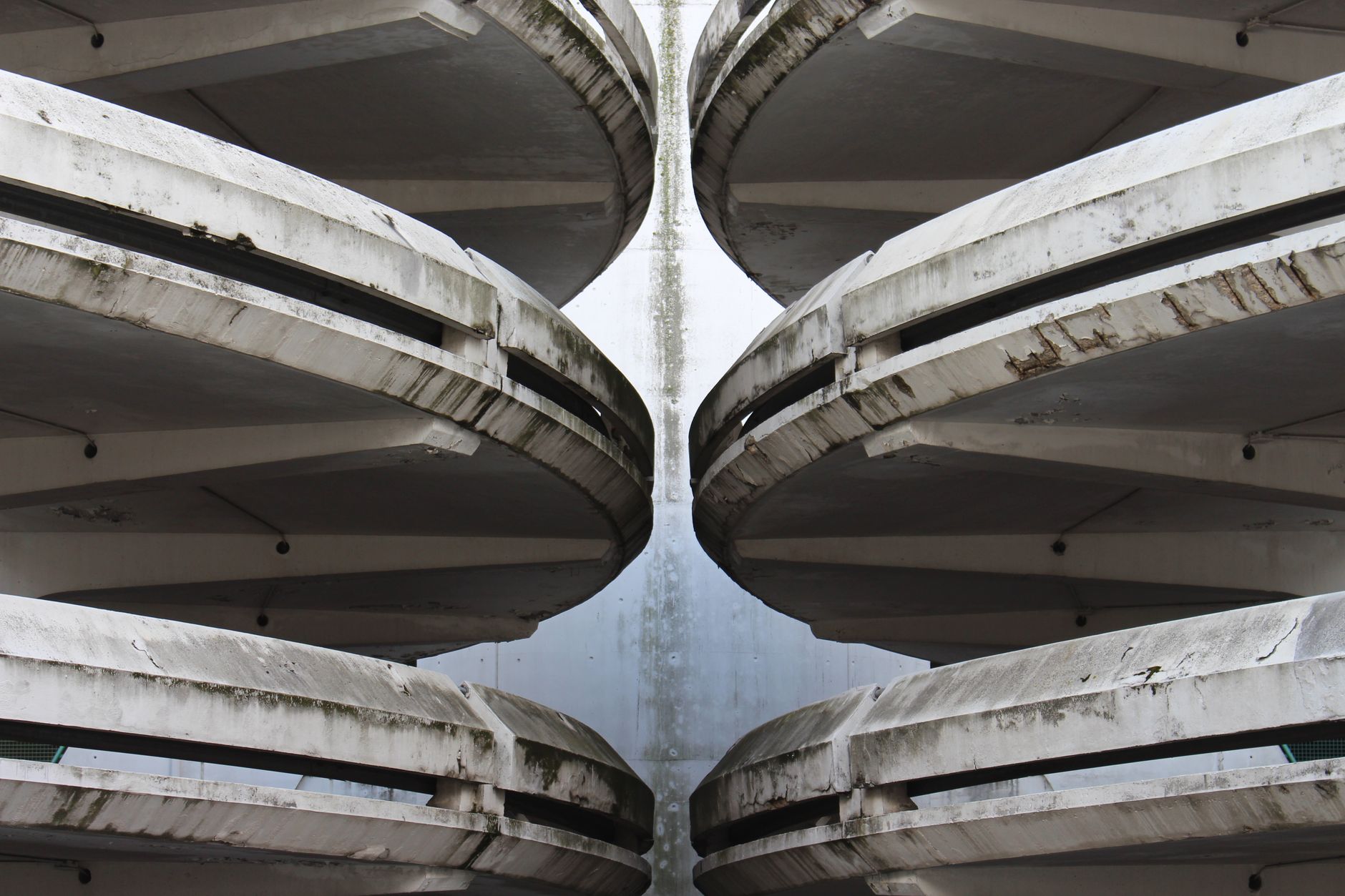 Exterior of a multi-story parking structure with concrete levels and open vehicle ramps, the type of site reviewed during a walkthrough assessment.